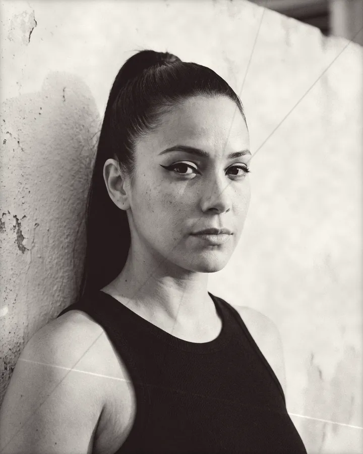 Portrait of a woman with a sleek high ponytail and sharp winged eyeliner, printed for the wall