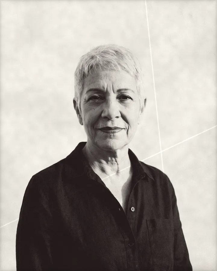 Portrait of a silver-haired woman with a short pixie cut and red lipstick, printed for the wall
