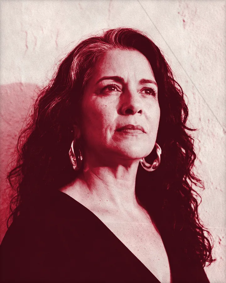 Portrait of a regal woman with thick wavy black hair and a silver streak, printed for the wall