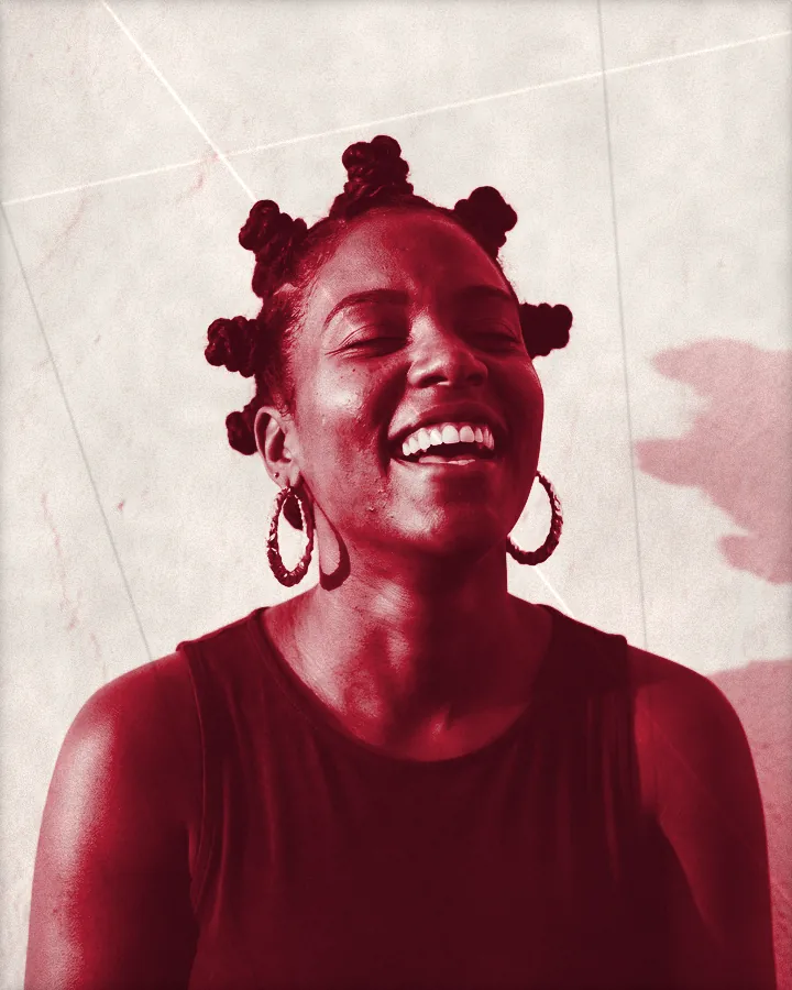 Portrait of a laughing woman with her hair in Bantu knots and big gold hoops, printed for the wall