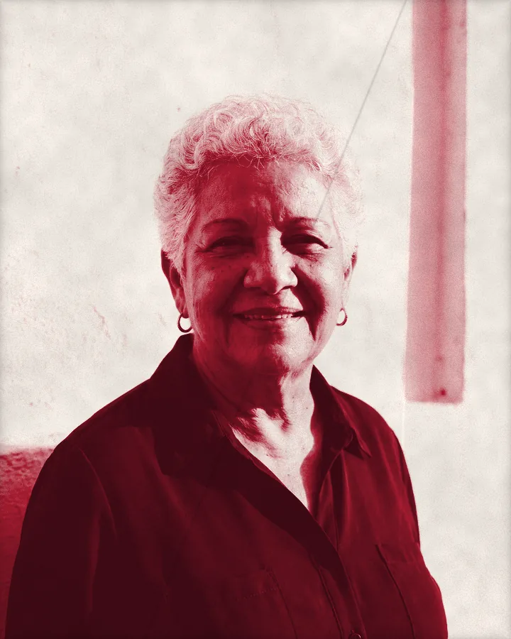 Portrait of an older woman with short white curly hair and a gentle smile, printed for the wall