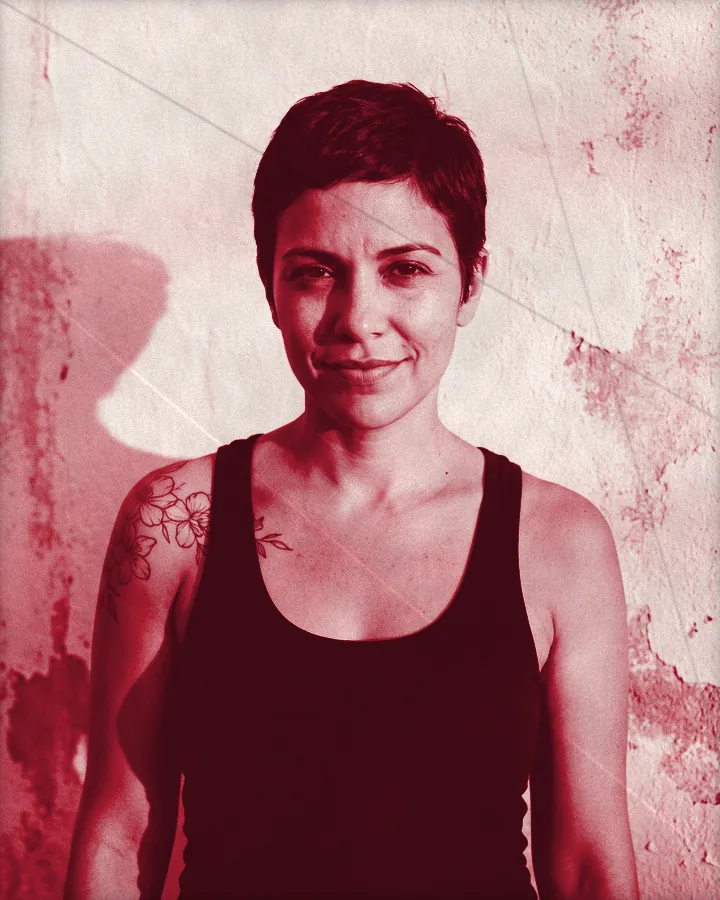 Portrait of a confident woman with a short dark pixie cut and a flower tattoo on her shoulder, printed for the wall