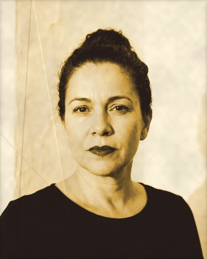 Portrait of a regal woman with dark wavy hair pulled back and red lipstick, printed for the wall