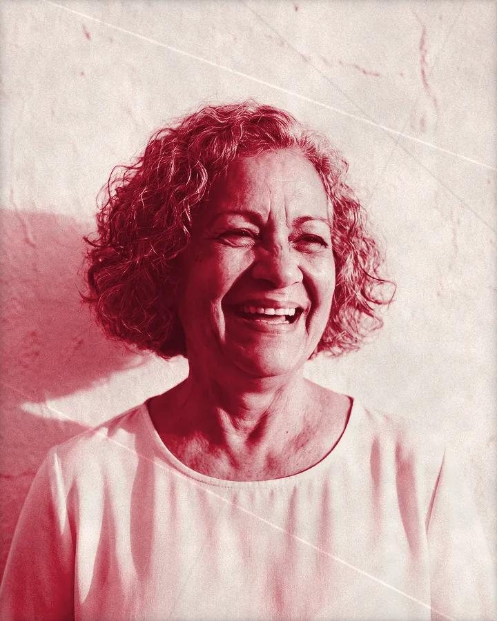 Portrait of a laughing older woman with a curly gray bob, printed for the wall