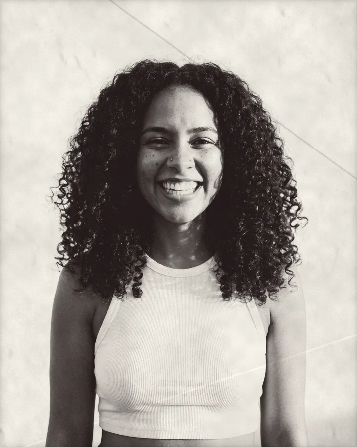 Portrait of a young woman with long voluminous ringlets and a nose stud, printed for the wall