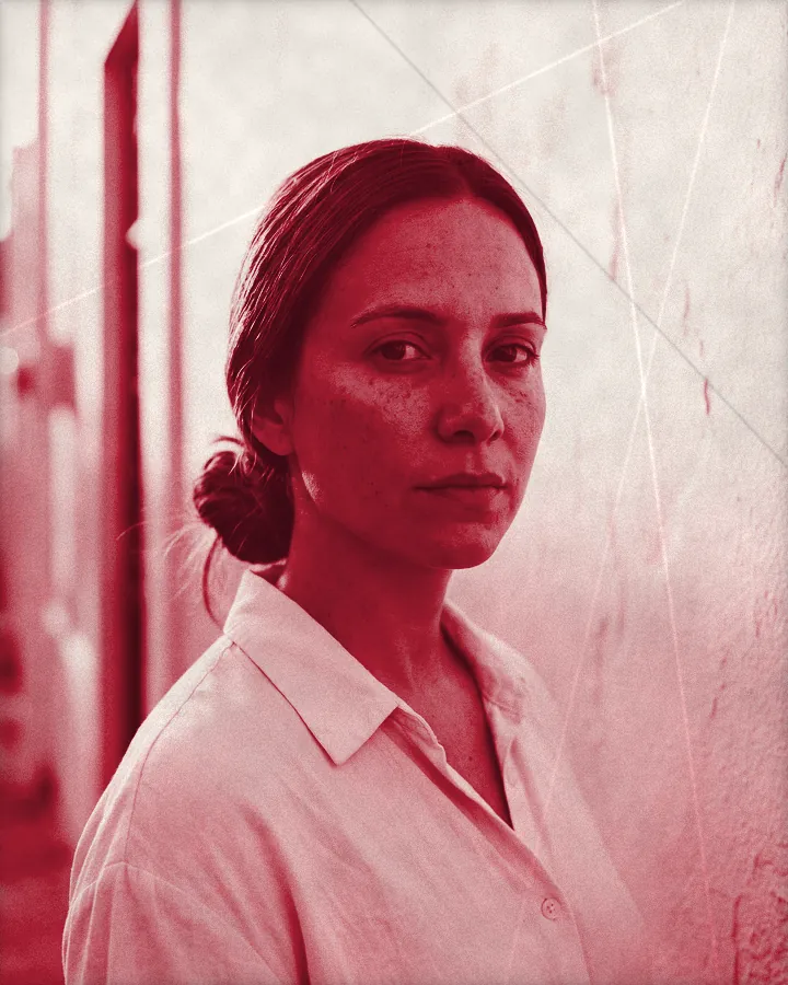 Portrait of a calm woman with brown hair in a low bun and a bare face, printed for the wall