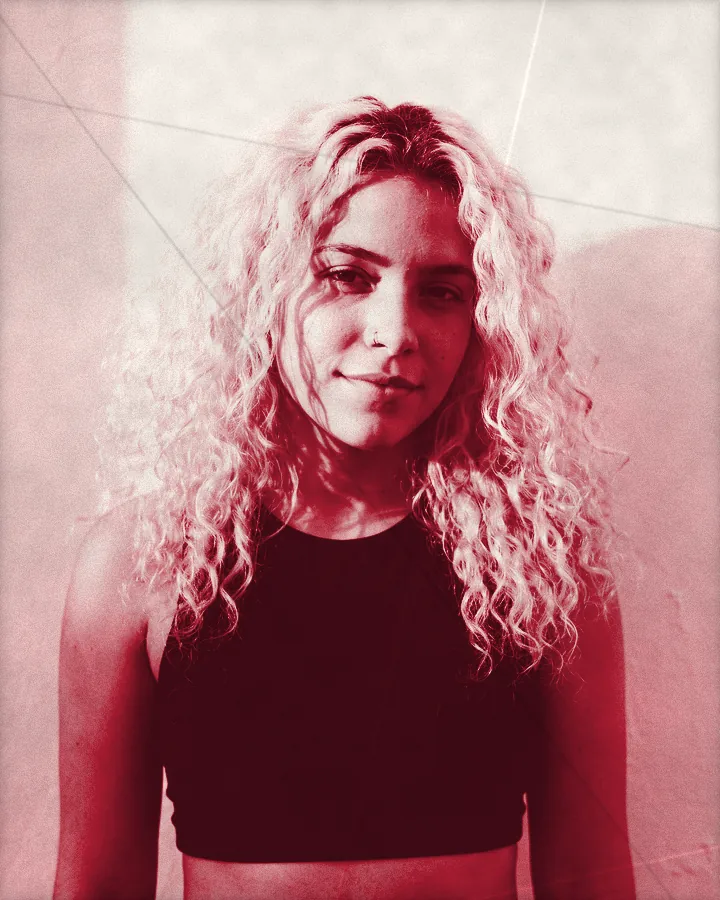 Portrait of a young woman with platinum curls and dark roots, printed for the wall